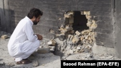 A man surveys the site of a blast targeting a state-run girls' school in Tank, South Waziristan tribal region, on September 22.