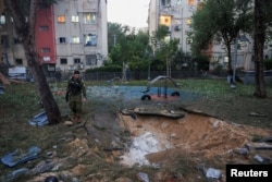 Israeli emergency services work at the scene of a missile strike that, according to Israel's military, was launched from Yemen and landed in Jaffa, Israel, on December 21.