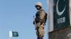 A Pakistani soldier stands guard at an outpost in the town of Angoor Adda near the Afghan border area targeted by the strikes. (file photo)