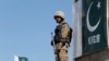 A Pakistani soldier stands guard at an outpost in the town of Angoor Adda near the Afghan border area targeted by air strikes on December 24. (file photo)