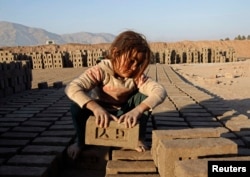 An Afghan girl works at a brick-making factory in Nangarhar Province.