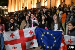 Protesters against the "foreign agent" law chant outside the Georgian parliament in Tbilisi on May 18.