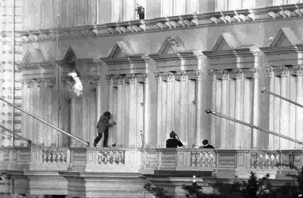 One of the hostages, BBC sound recordist Sim Harris, climbs along the balcony following two explosions. His escape was watched by millions on live television. &quot;They were throwing in grenades and the room was burning, so I had to crawl out onto the balcony and I was ready to jump actually. I thought, well, if I could get out of this with a broken leg I would be all right,&quot; Harris told the BBC. Harris went to the embassy on April 30 with his colleague, BBC journalist Chris Kramer, over visa issues.