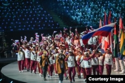 The Russian delegation enters the arena during the opening ceremony.