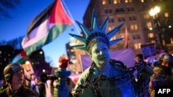 An activist dressed as the Statue of Liberty is pulled in shackles as protesters rally in Washington, D.C. in support of Palestinians during Israeli Prime Minister Benjamin Netanyahu's visit to the U.S capital on February 4.