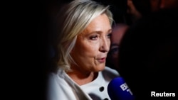 French far-right leader Marine Le Pen talks to journalists on July 7.