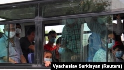 People wearing protective face masks ride a bus in Ashgabat, despite the country officially having had no cases of COVID-19.