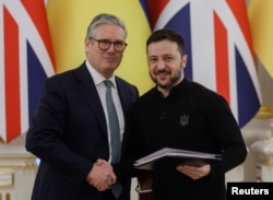 U.K. Prime Minister Keir Starmer and Ukrainian President Volodymyr Zelenskiy shake hands after meeting in Kyiv on January 16.