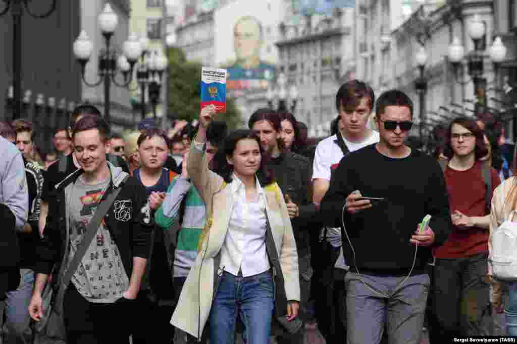 A protester holds aloft a copy of Russia&#39;s constitution, which guarantees freedom of assembly and free speech.&nbsp;