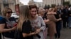 Family members and supporters comfort one another as they gather on Kyiv's Maidan on July 29 to mark the first anniversary of the attack on a prison building in Olenivka in Russian-occupied Ukraine that killed dozens of Ukrainian military prisoners. 