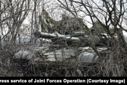 A camouflaged Ukrainian tank takes part in drills.