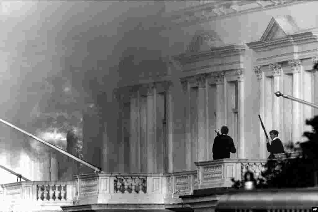 Armed police look from an adjoining balcony to the Iranian Embassy in London on May 5, 1980, when units of the Special Air Service (SAS) helped police end the siege.