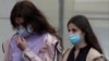 Krestina (left) and Angelina Khachaturyan, two of the three sisters accused of killing their father, arrive for a court hearing in Moscow in July. 