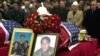 People in Pristina pay their last respects in 2002 to the three Bytyqi brothers who were killed in Serbia in 1999. 