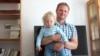 Andrey Sharenda, pictured with son Stakh in 2017, says he is trying to create some sense of normalcy for his children during their exile in Vilnius since his wife, Palina Sharenda-Panasyuk, was imprisoned in their native Belarus.