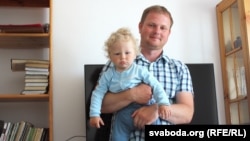 Andrey Sharenda, pictured with son Stakh in 2017, says he is trying to create some sense of normalcy for his children during their exile in Vilnius since his wife, Palina Sharenda-Panasyuk, was imprisoned in their native Belarus.