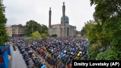 Russian Muslims, who are the second largest denomination in the country, pray outside a mosque as they celebrate Eid al-Adha in St. Petersburg in July. 