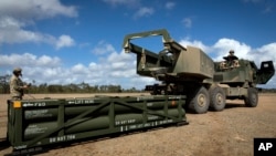 Soldiers prepare to load an Army Tactical Missile System (ATACMS) onto a High Mobility Artillery Rocket System (HIMARS). (file photo)