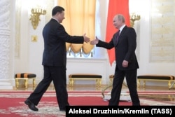 Russian President Vladimir Putin (right) greets his Chinese counterpart, Xi Jinping, in Moscow in 2019. The growing pressures of the superpower conflict may become increasingly hard for small countries as they must also deal with Russia, which is growing closer to China as ties between Moscow and Washington reach historic lows.