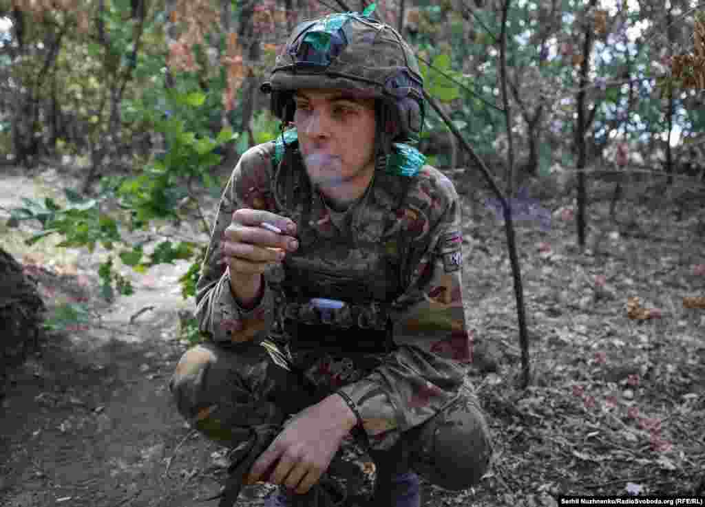 Sasha, 22, a member of the unit who previously worked as a welder, enjoys a cigarette.