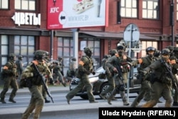 Armed security forces move to intervene against protesters in Minsk on August 10.