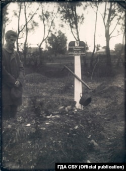 Mykola Bokan stands at his son Konstantin's final resting place. A small handwritten note at the bottom of the photograph says "Kostia's grave." (Archive of the Security Service of Ukraine, fonds 6, case № 75489-fp, volume 2)