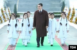 The parents of children chosen to take part in the New Year's events (such as those pictured here with Former President Gurbanguly Berdymukhammedov in 2018) are ordered to pay for the costumes.