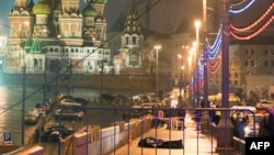 The body of Russian opposition leader Boris Nemtsov, covered with plastic, lies on Moskvoretsky Bridge near St. Basil Cathedral in central Moscow early on February 28.