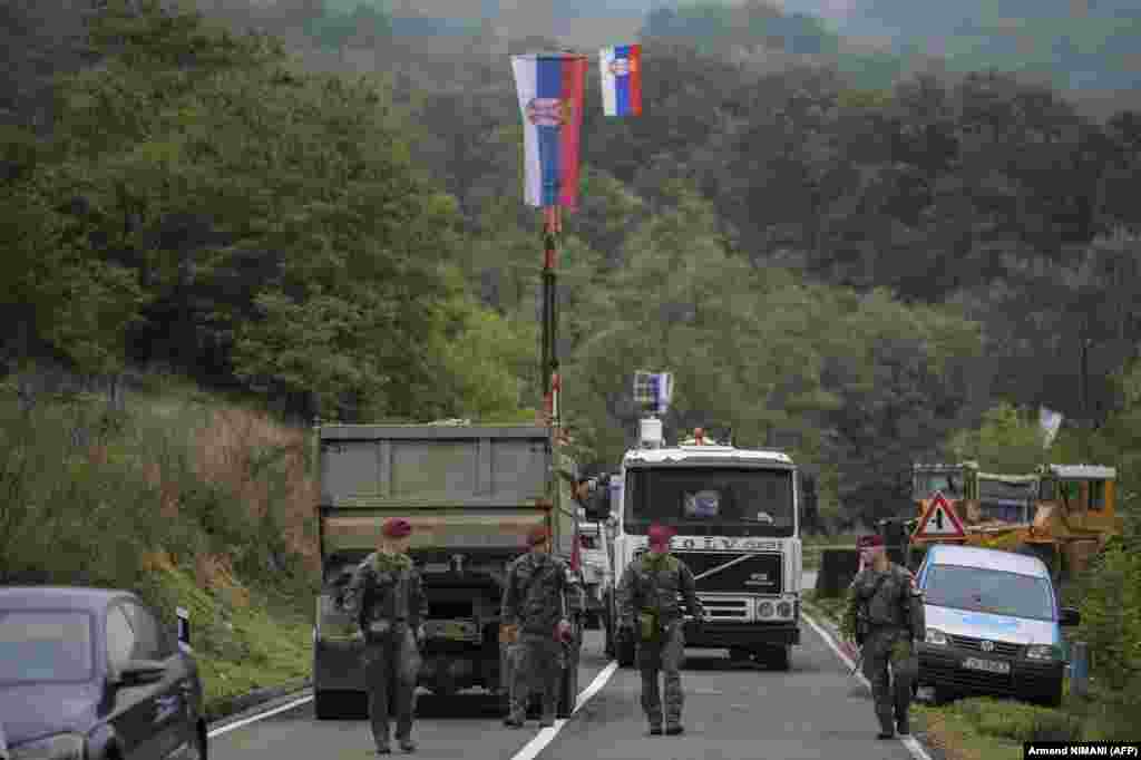 NATO soldiers patrol near Jarinje on September 28, as the international community, led by the European Union, called for talks to ease tensions between Serbia and Kosovo. NATO has led the KFOR peacekeeping force since 1999, with around 4,000 troops from 28 countries, after a 78-day bombing campaign by the military alliance ended a war that left more than 10,000 dead.