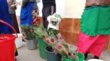 A newspaper page featuring Turkmenistan's "Protector" Gurbanguly Bedymukhammedov is used to wrap flowers.