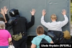 Riot police detain people on Prytytski Street in Minsk, near where Alyaksandr Taraykouski was killed during protests on August 10. Taraykouski was one of the first people to die in the postelection crackdown, which has claimed several lives.