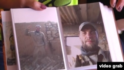 Yelena Matveyeva shows photos of her husband, Stanislav, who is thought to have died fighting in Syia. "Wherever they sent them, there was no defense. They just threw them into battle like pigs," she contends. "The government should avenge them somehow."