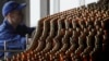 An employee works at a line bottling beer at a Carlsberg brewery in Krasnoyarsk. (file photo)