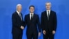 French President Emmanuel Macron (center) is welcomed by U.S. President Joe Biden (left) and NATO Secretary-General Jens Stoltenberg as they attend the NATO summit in Washington on July 10.