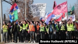 Students hold flags of Serbia and their university departments as they walk to a protest in Kragujevac, Serbia, on February 15. 