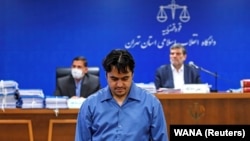 Ruhollah Zam at his trial in Tehran earlier this year. 