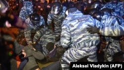 Russian riot police detain activists protesting on May 15 against a plan to build an Orthodox church in a park in the Russian Urals city of Yekaterinburg.