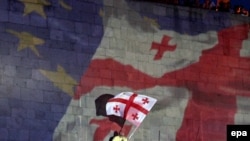 A projection of the Georgian and EU flags during celebrations for the Association Agreement with the EU in Tbilisi in June 2014.