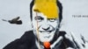 A worker paints over graffiti of jailed Kremlin critic Aleksei Navalny in St. Petersburg in April.