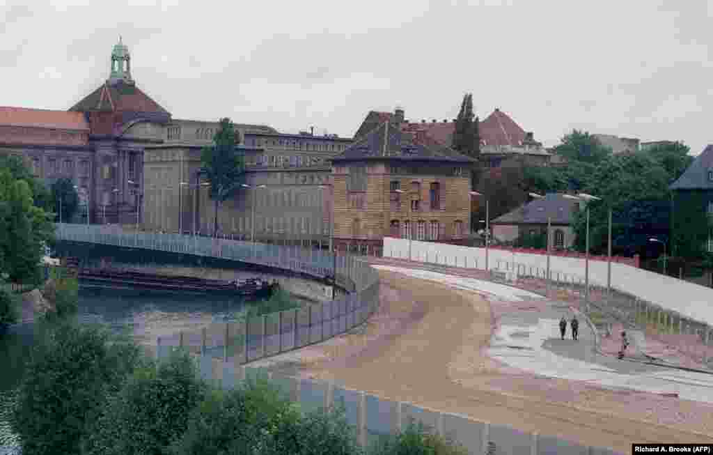 East German soldiers patrolling along the wall near Berlin&#39;s train station in September 1987. The buffer between the inner and outer walls was known as the &quot;death strip&quot; and was designed to offer a clear line of fire for border guards under orders to shoot at anyone trying to flee.&nbsp;