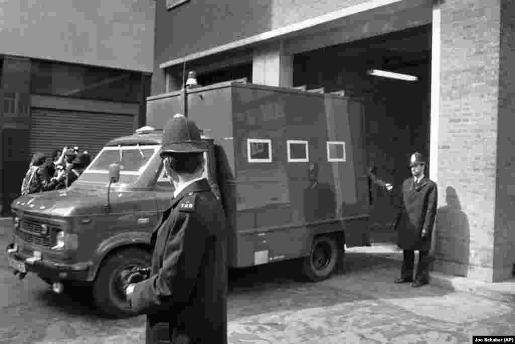 Under heavy security, a police van carries siege suspect Fowzi Badavi-Negad to the Horseferry Magistrates Court in London on May 8, 1980.