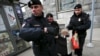 Russian police detain a protester against Russian President Vladimir Putin after she took part in a lone picket in central Moscow in April.