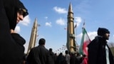 Supporters of the Islamic republic march past ballistic missile models in Tehran during the 46th anniversary of the Islamic revolution, February 10