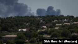 Smoke rises in the sky after shelling at the front line in the Donbas region on July 13.
