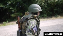 A young Japanese cosplayer wearing a badge of the separatist People’s Militia of the Donbas, which was listed as a terrorist organization in Ukraine.