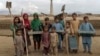 Afghan children pose for a photo at the brick factory where they work on the outskirts of Kabul. There are at least 1 million child laborers in Afghanistan, where incomes have plummeted and millions are on the brink of starvation.