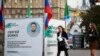 People in Novosibirks walk past a campaign tent for Sergei Boiko, who heads the local office of opposition politician Aleksei Navalny in Novosibirsk and is running for the city legislature.