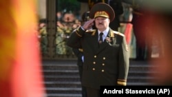 Alyaksandr Lukashenka salutes during his inauguration ceremony in Minsk on September 23, more than a month after a much-disputed presidential vote that according to official figures he won by a landslide. 