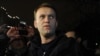 Aleksei Navalny speaks to journalists and supporters outside a police station in Moscow in December 2011.