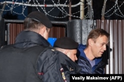 Russian police officers detain opposition leader Aleksei Navalny upon his release from a Moscow detention center on September 24.